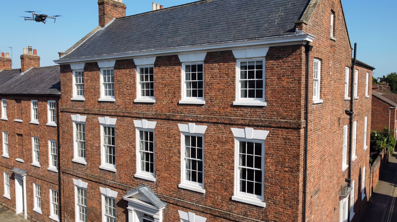 Professional drone capturing detailed building facade and elevation imagery