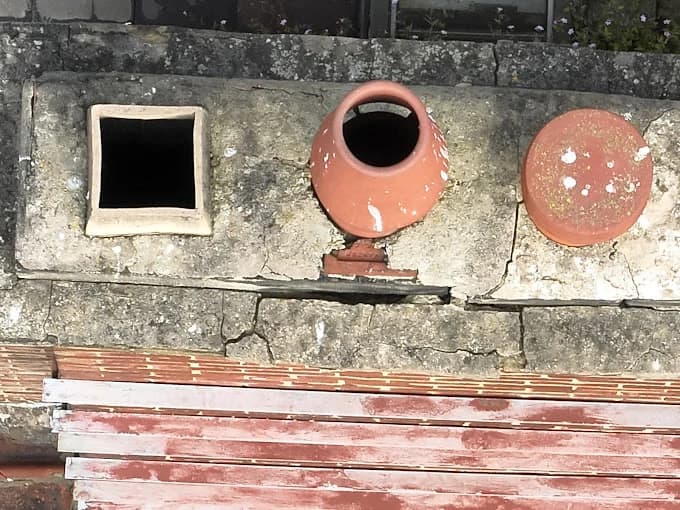 Detailed drone inspection of chimney stack and roof flashing condition