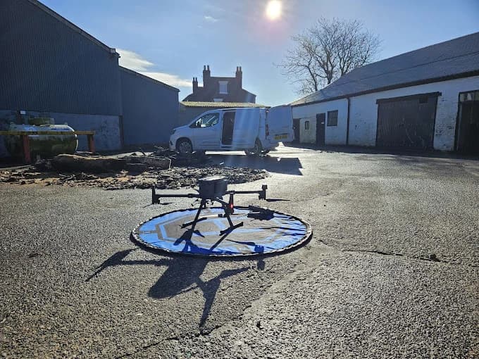 Professional drone on landing pad preparing for commercial building roof inspection