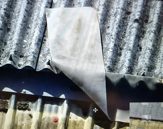 Close-up drone inspection of roof tiles showing detailed condition assessment