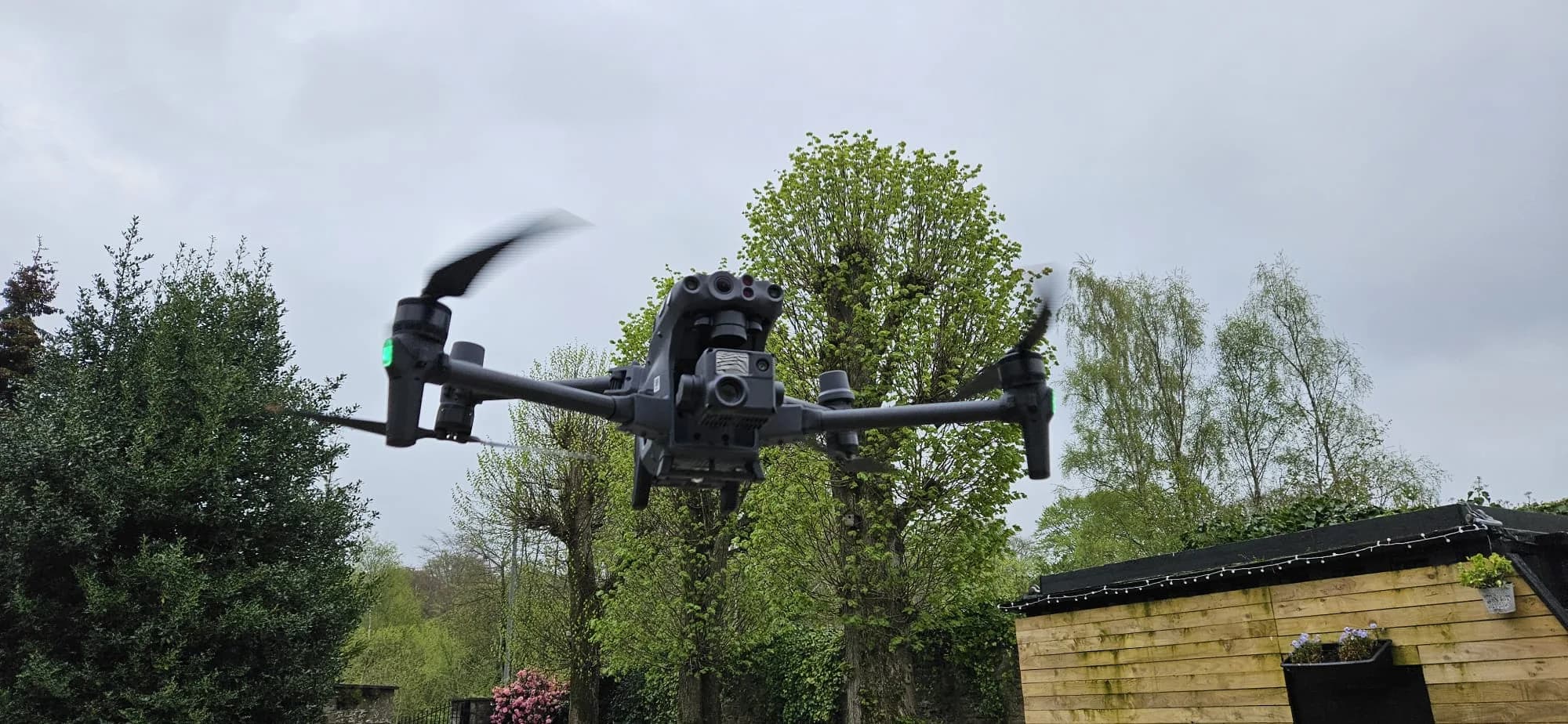 Professional drone performing residential roof inspection over UK property
