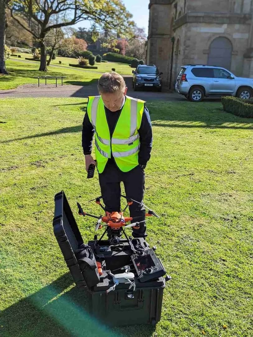 Professional pilot preparing LiDAR equipment for survey mission