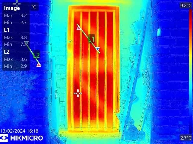 Thermal imaging detecting heat loss around building entrance and windows