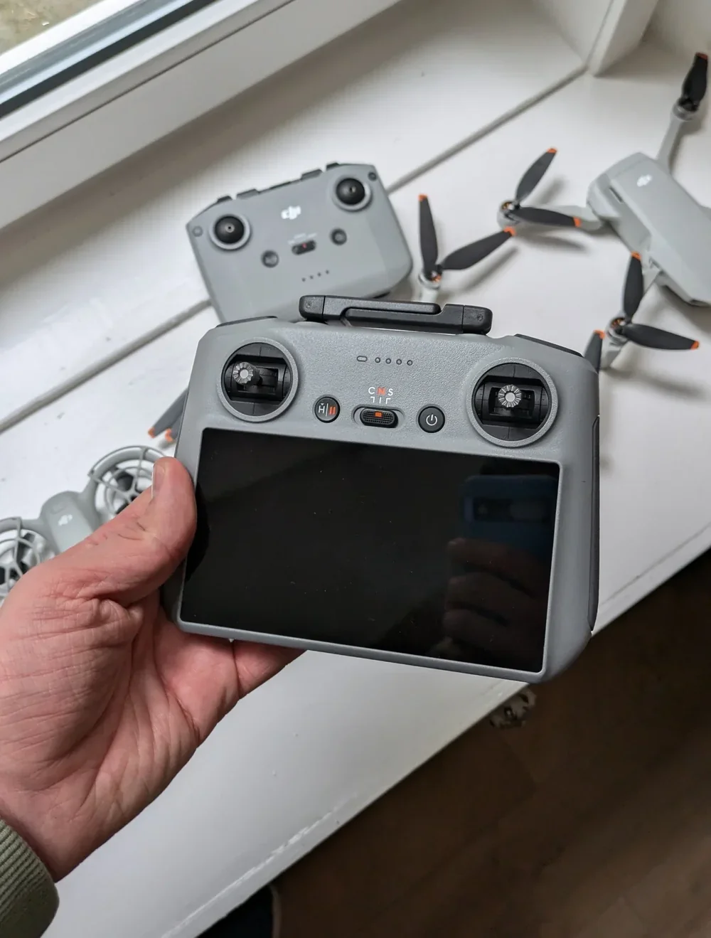 DJI drone with the manufacturer serial number label visible on the body