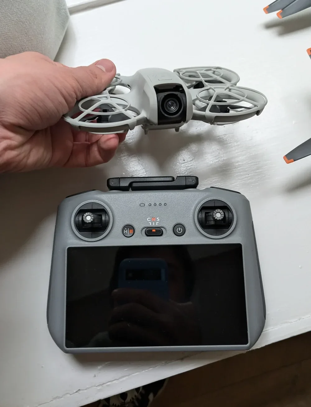 Compact sub-250g drones in hand