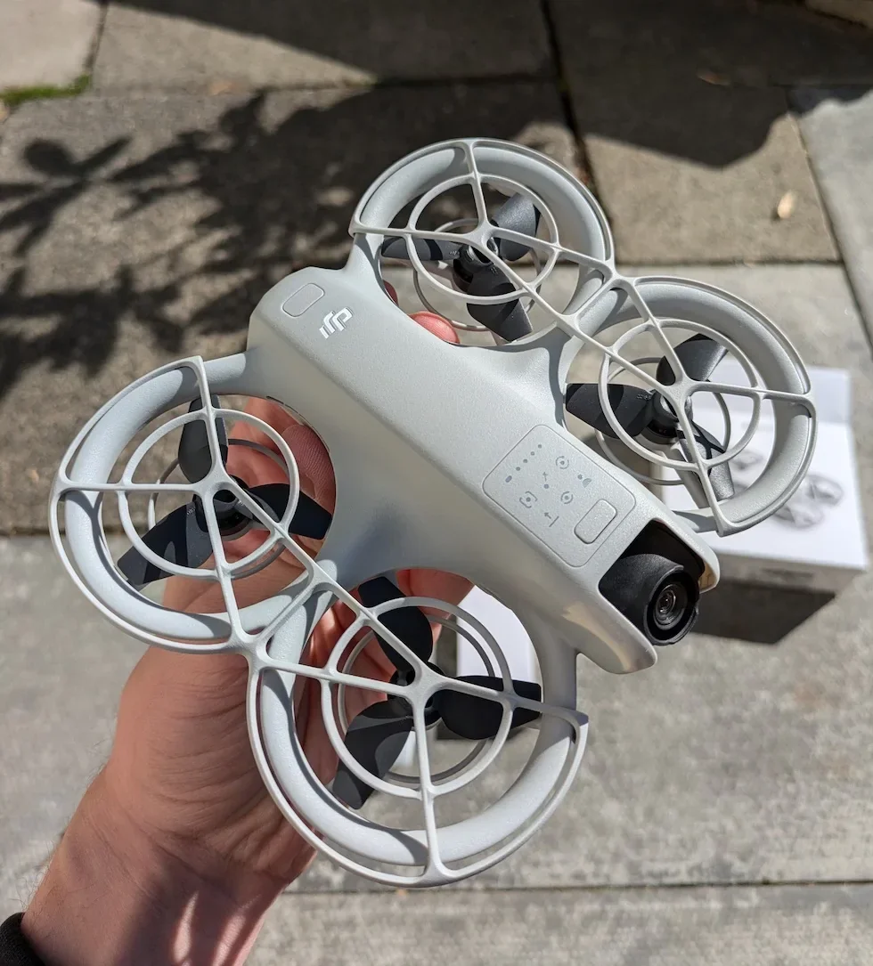 DJI Neo 2 and remote controller placed side by side within half a metre on a flat surface