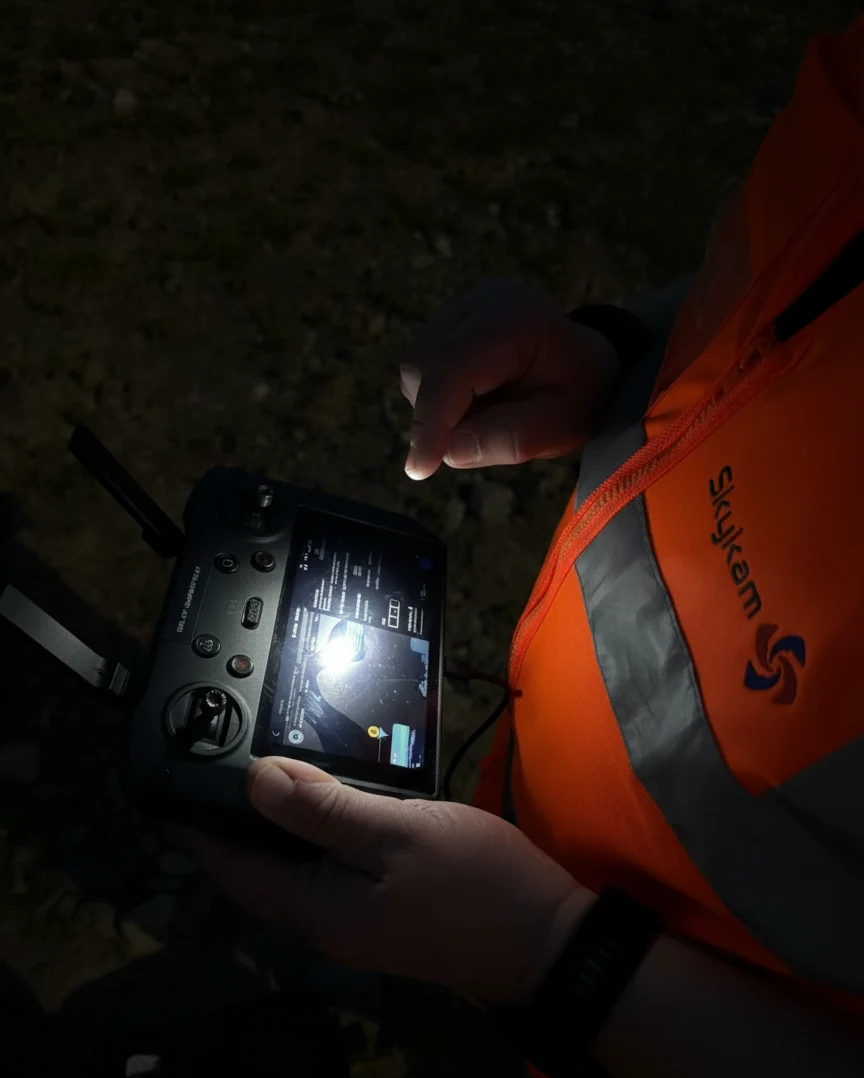 Drone pilot tracking a small drone in low-light conditions