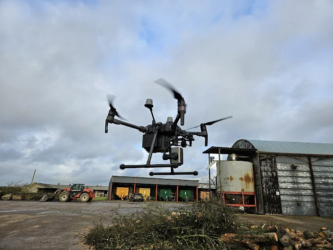 A drone pilot watching a hover test before launching a paid shoot
