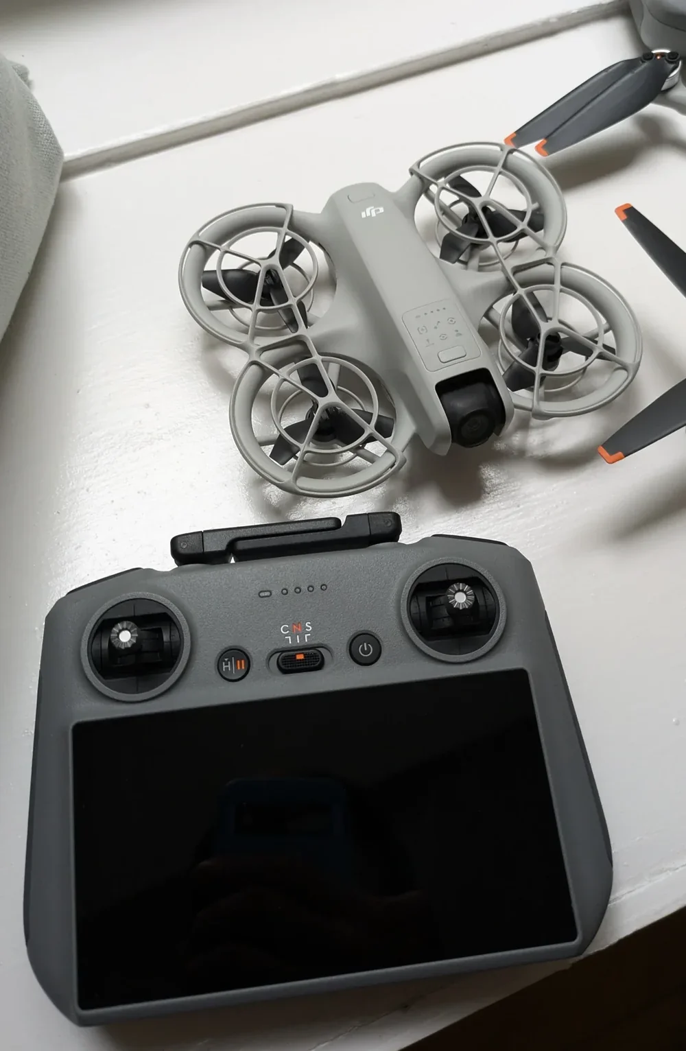 DJI Mini 4K folded beside batteries