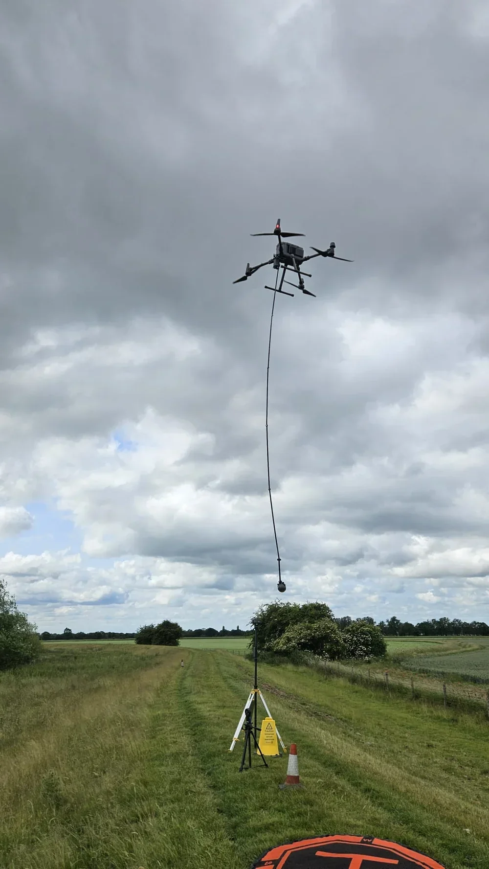 Drone pilot checking conditions before take-off in breezy weather
