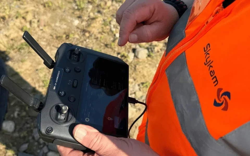 Drone site survey in gusty conditions with visible wind indicators