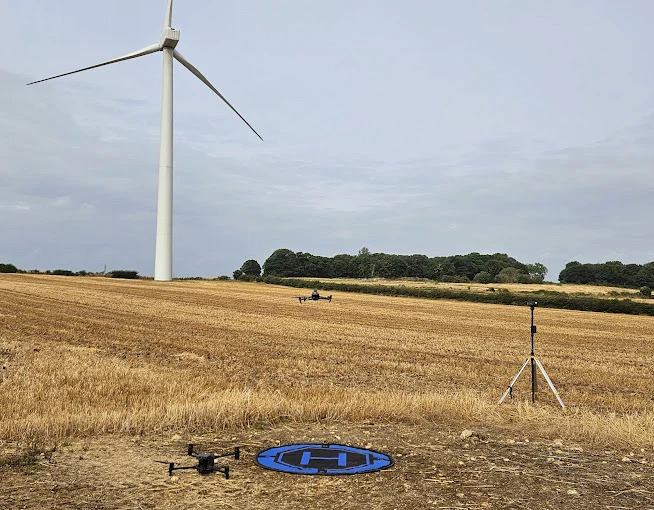 Drone pilot examining a building roof via drone