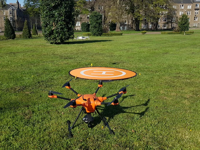 Drone on high-visibility landing pad, pre-flight setup