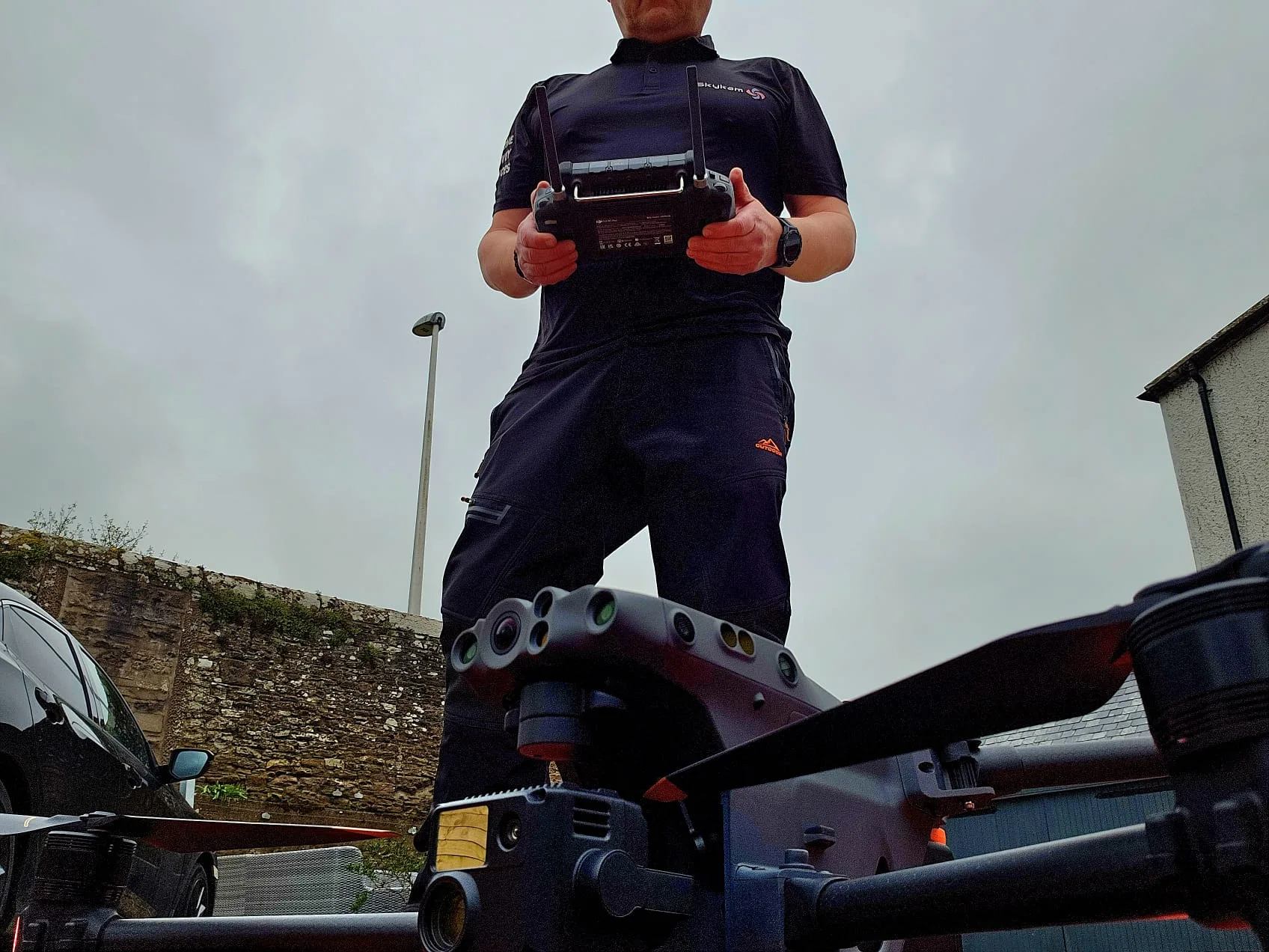 Drone pilot holding DJI smart controller over Matrice airframe