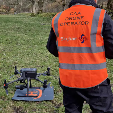 Skykam drone operator in high-visibility clothing with a Matrice drone