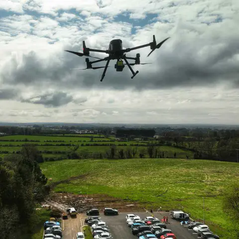 DJI Matrice drone flying high over UK countryside